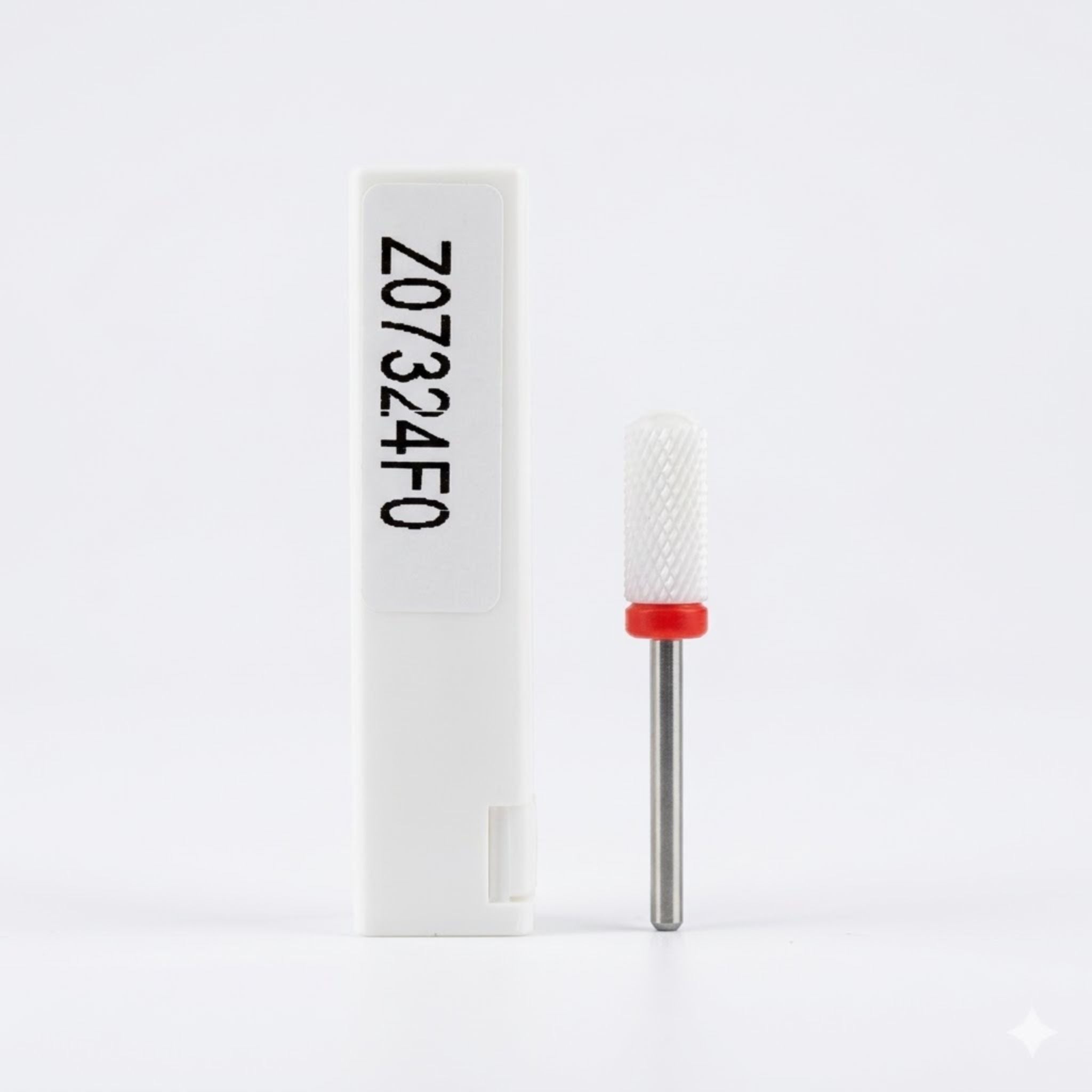 Nail drill bit with red cap and white box on a white background