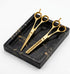 Set of gold scissors on a black marble tray - viva instruments 