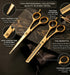 Gold professional hair cutting scissors with detailed features on a dark marble background - viva instruments 