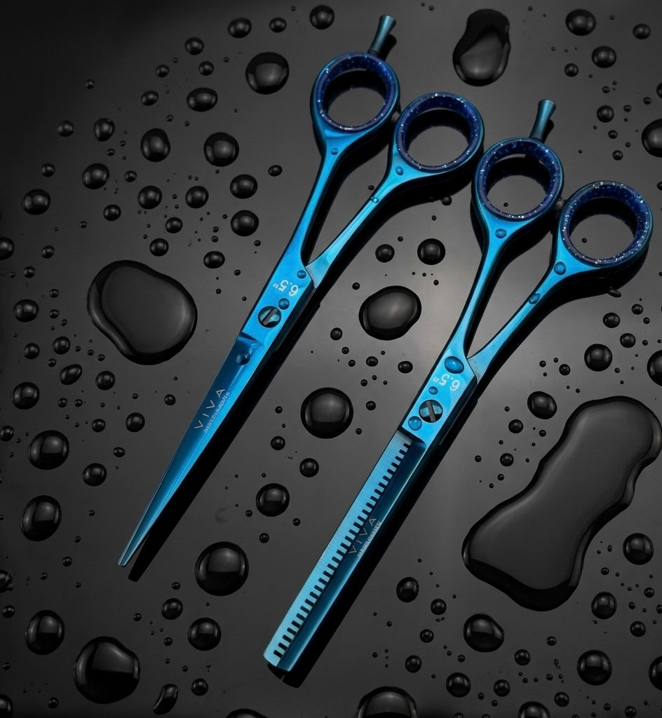 Blue barbe scissors on a black surface with water droplets - viva instruments 