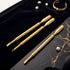 Gold cuticle pushers nail tools with 'VIVA' branding on a black and gold marble surface.