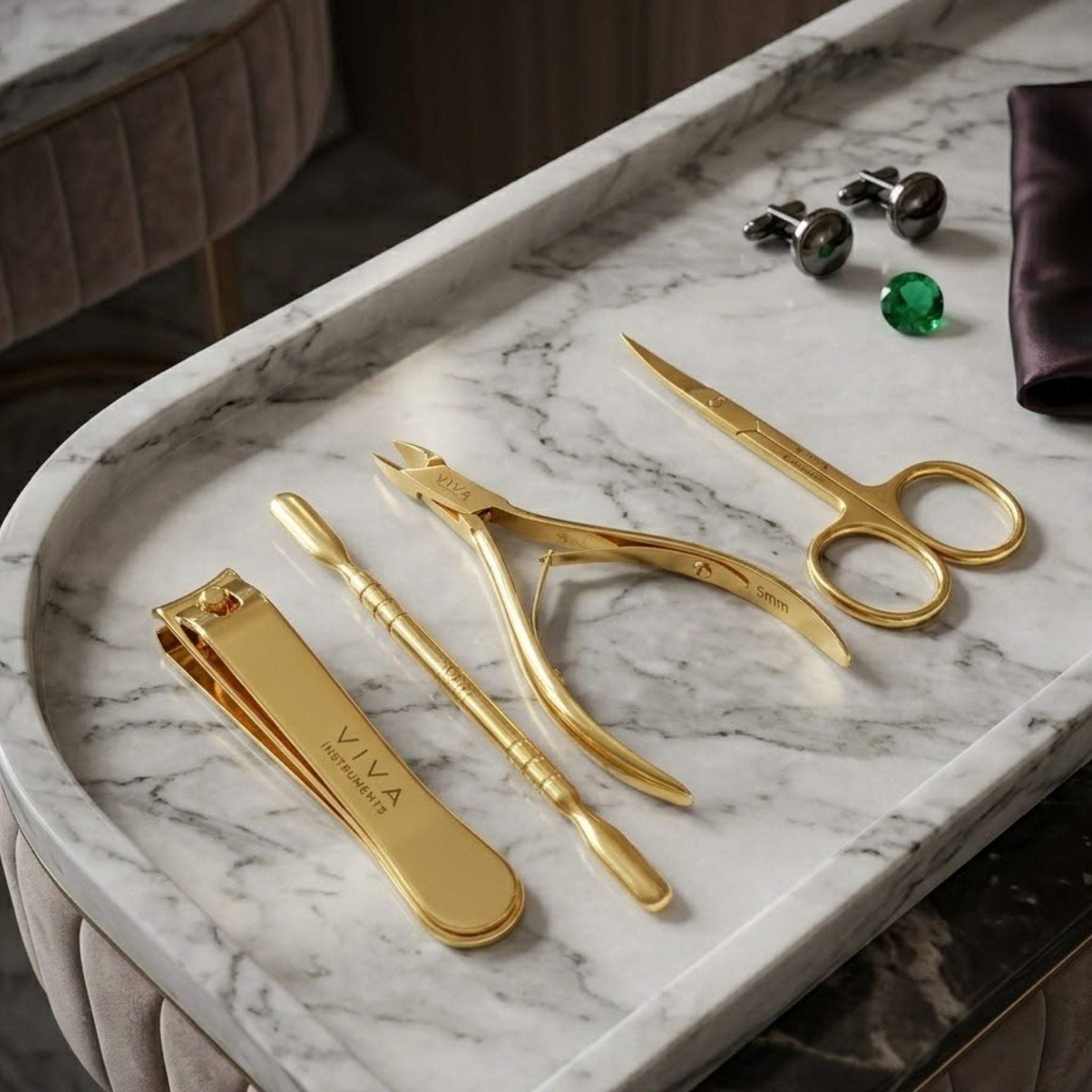 Gold manicure set on a marble surface with accessories in the background - viva instruments