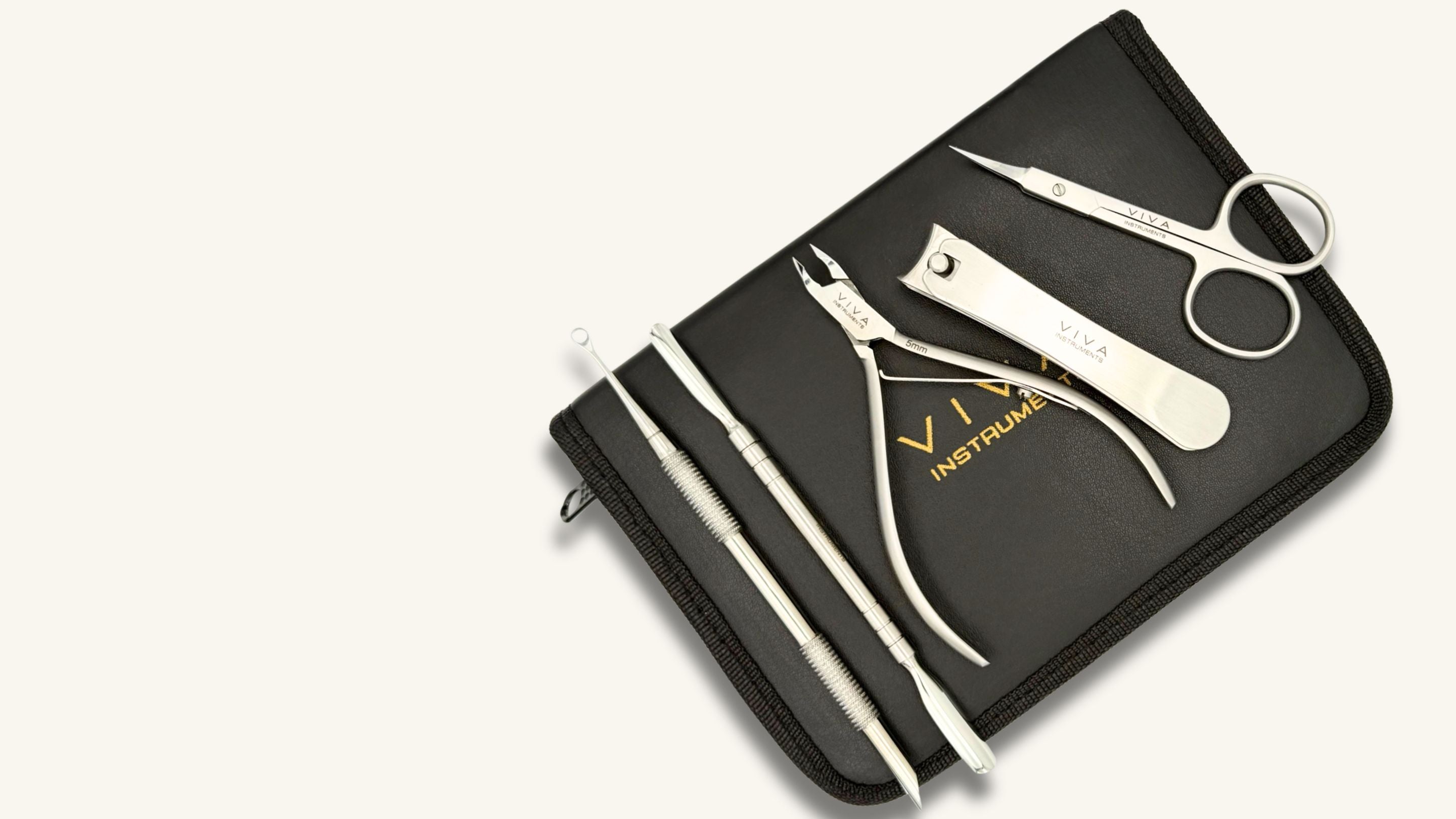 Set of nail care tools including scissors, pliers, and files on a black case with 'Viva' branding.