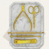 Gold manicure set with scissors, cuticle nipper, and other tools on a marble tray - viva instruments 